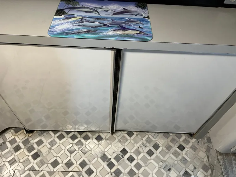 Slide: The Image of White cabinets and patterned floor in 1987 Sea Ray 460 yacht interior. - 45