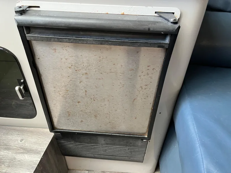 Slide: The Image of 1987 Sea Ray 460 interior with built-in appliance and seating. - 46