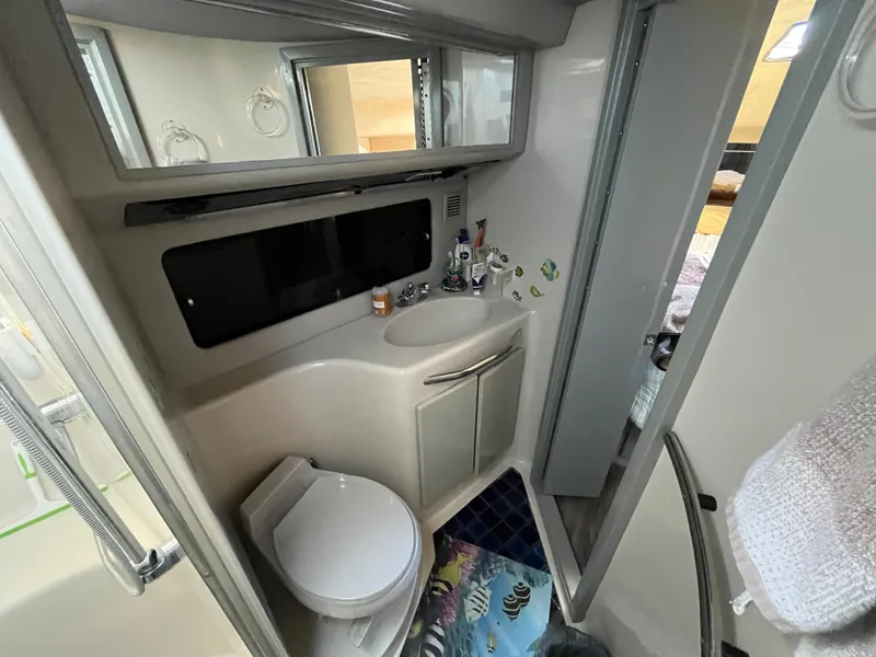 Slide: The Image of Bathroom interior of 1987 Sea Ray 460 yacht, featuring toilet and sink. - 47