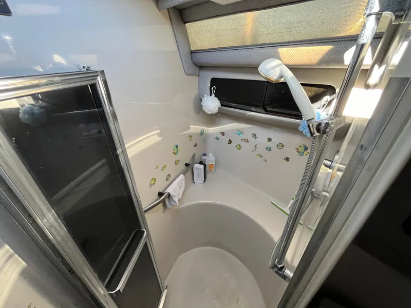 Slide: The Image of 1987 Sea Ray 460 yacht bathroom with shower, fish decals, and modern fixtures. - 49