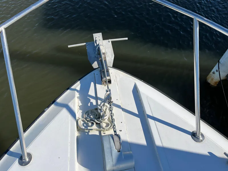 Slide: The Image of Bow of 1987 Sea Ray 460 boat with anchor chain, railing, and calm water. - 6