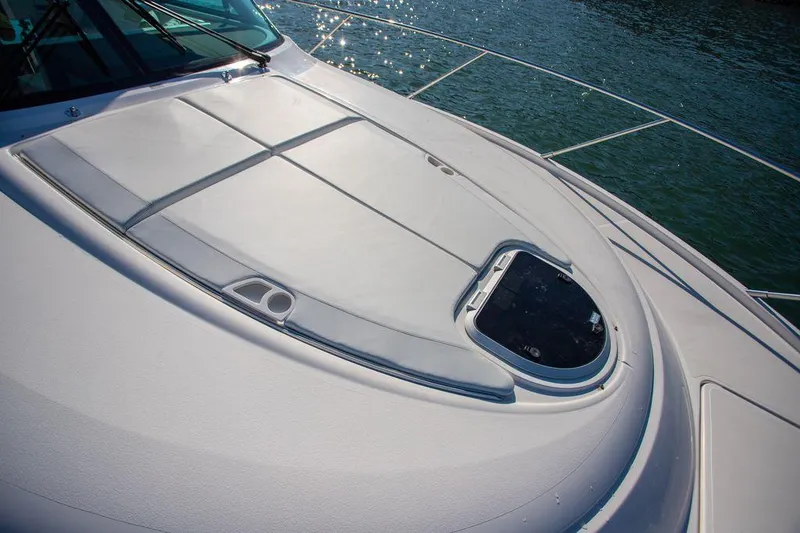 Slide: The Image of 2018 Tiara Yachts C44 Coupe deck with sunroof, glistening on the water. - 20