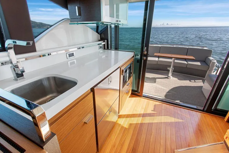 Slide: The Image of Luxurious 2018 Tiara Yachts C44 Coupe interior with ocean view and modern kitchen. - 25