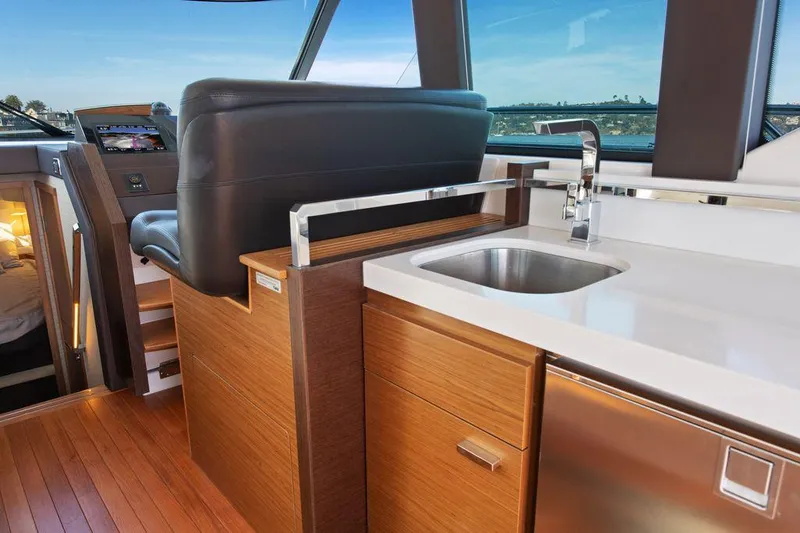 Slide: The Image of Interior of 2018 Tiara Yachts C44 Coupe with modern kitchen and seating area. - 27