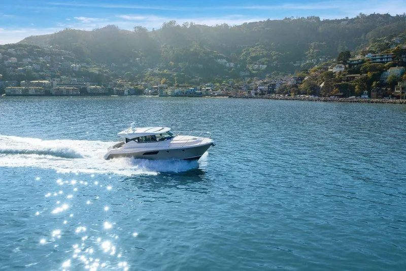 Slide: The Image of 2018 Tiara Yachts C44 Coupe cruising on a sunny, scenic bay. - 43
