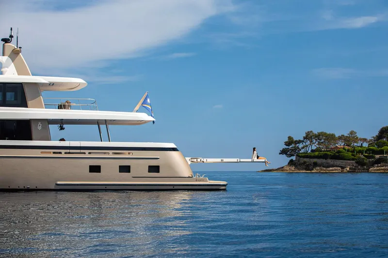 Slide: The Image of Van der Valk Custom 34M Explorer yacht on serene blue waters, 2021 model. - 5