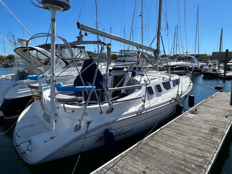 Slide: The Image of 2001 Hunter 320 sailboat docked at marina, clear blue sky. - 1