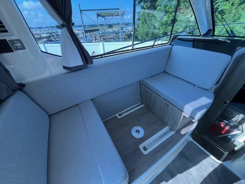 Slide: The Image of Interior of 2025 Bayliner Trophy T29 Explorer with gray seating and scenic window view. - 12