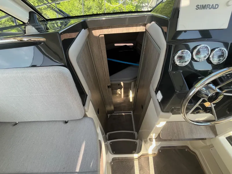 Slide: The Image of Interior view of 2025 Bayliner Trophy T29 Explorer boat cockpit with steering wheel and seating. - 15