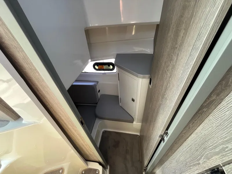 Slide: The Image of Interior cabin of 2025 Bayliner Trophy T29 Explorer, featuring compact seating and modern design. - 16