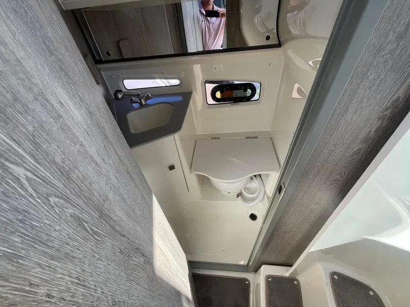 Slide: The Image of Interior of 2025 Bayliner Trophy T29 Explorer boat bathroom with sink and toilet. - 19