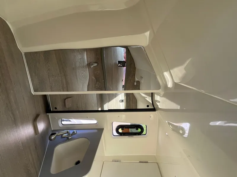 Slide: The Image of Interior of 2025 Bayliner Trophy T29 Explorer, featuring a compact sink and mirror. - 20