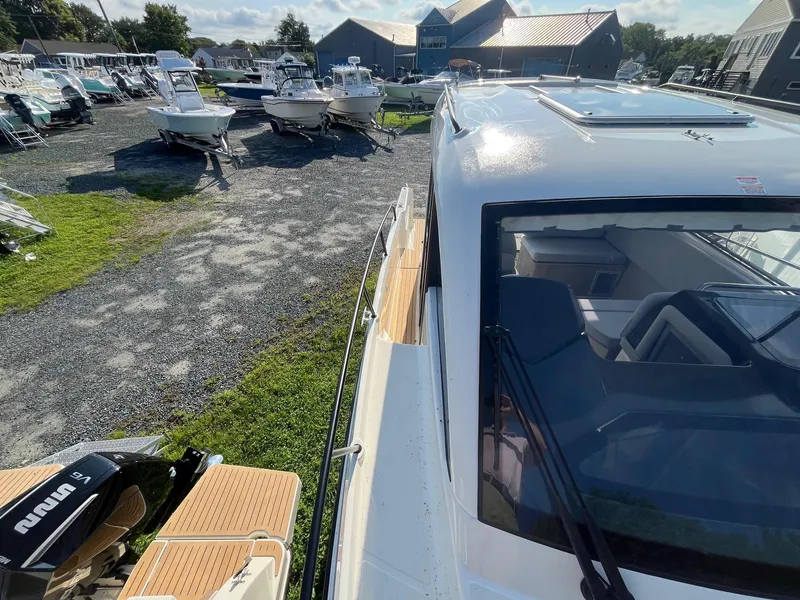 Slide: The Image of 2025 Bayliner Trophy T29 Explorer in a boatyard, showcasing sleek design and modern features. - 25