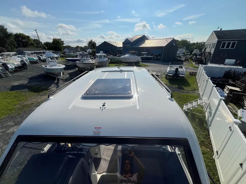 Slide: The Image of 2025 Bayliner Trophy T29 Explorer boat in a marina, viewed from above. - 27