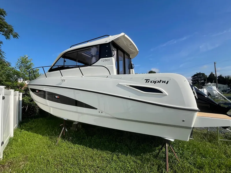 Slide: The Image of 2025 Bayliner Trophy T29 Explorer boat on display, side view under clear blue sky. - 4