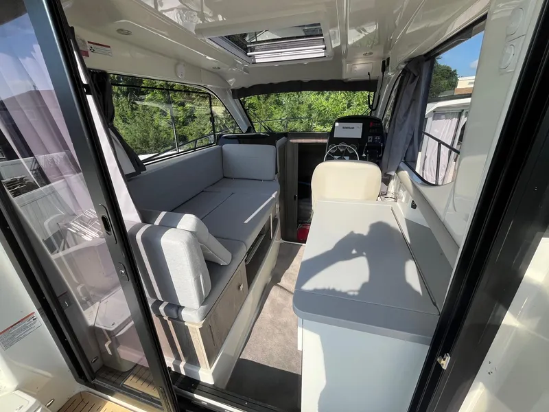 Slide: The Image of Interior of 2025 Bayliner Trophy T29 Explorer, featuring modern seating and helm area. - 7