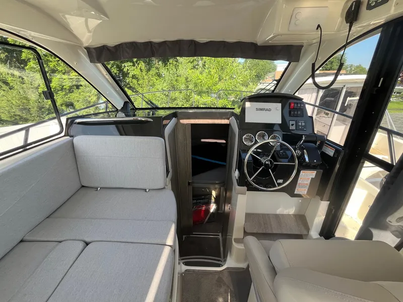 Slide: The Image of Interior of 2025 Bayliner Trophy T29 Explorer with modern helm and seating. - 9