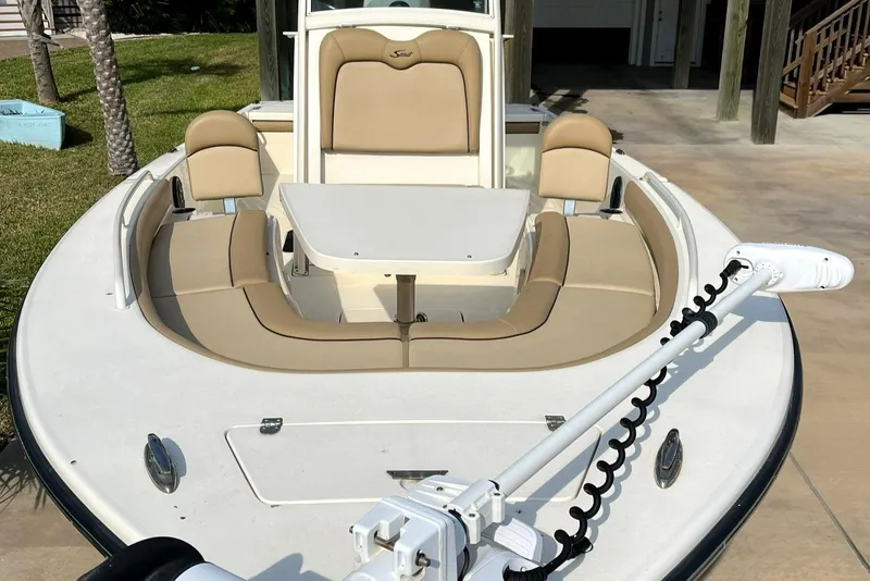 Slide: The Image of 2018 Scout 251 XSS boat with beige seating and trolling motor. - 11