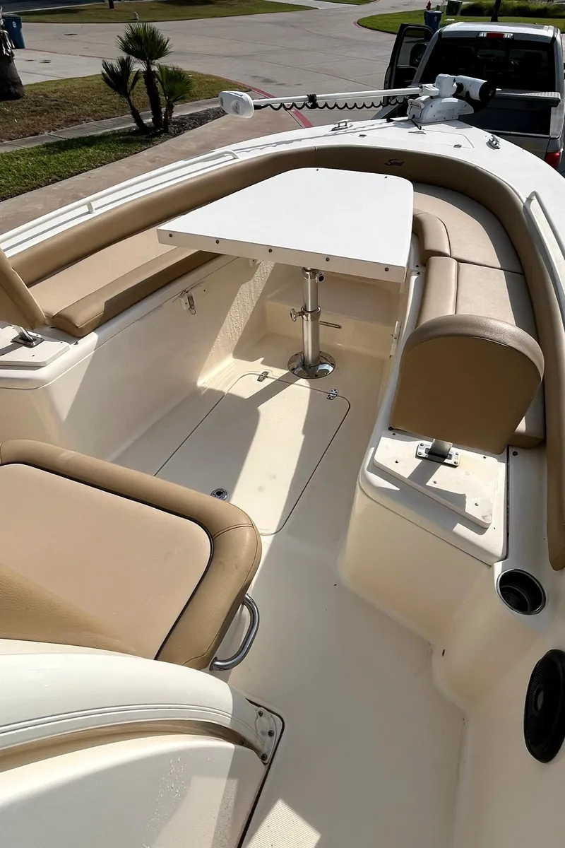 Slide: The Image of 2018 Scout 251 XSS boat interior with seating and table. - 13