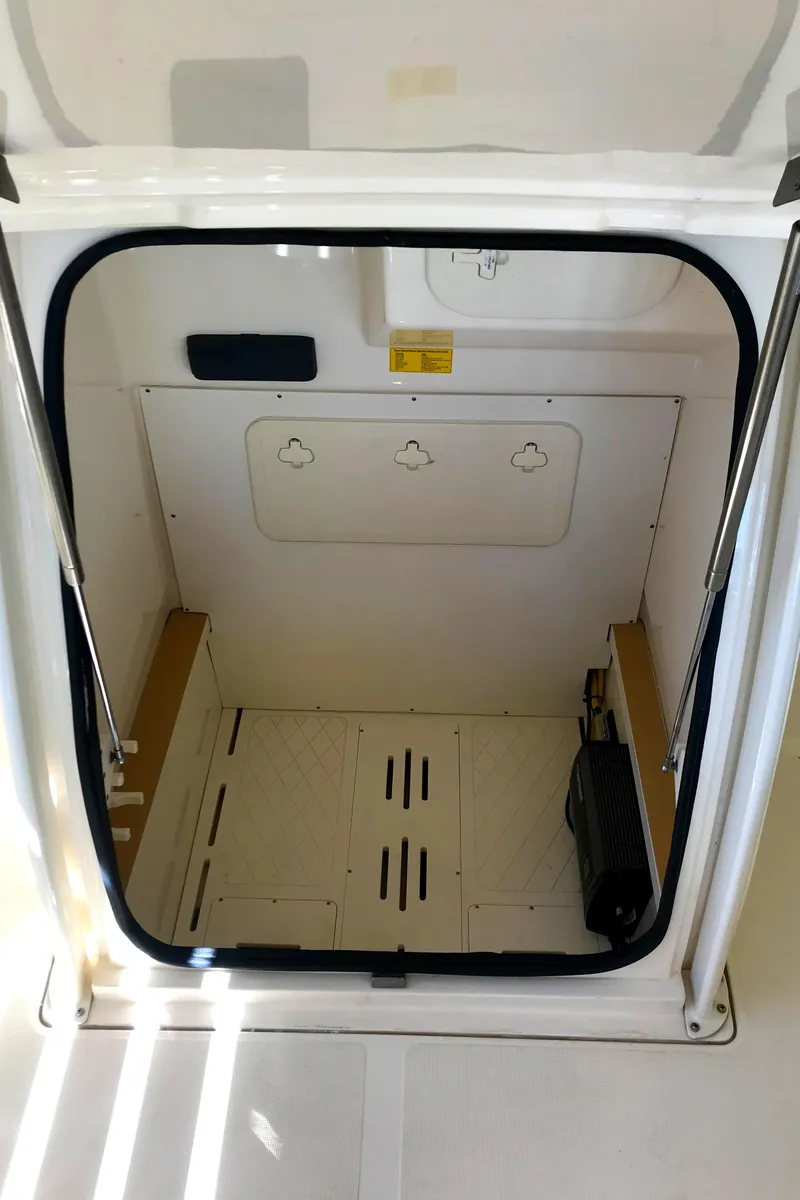 Slide: The Image of 2018 Scout 251 XSS boat storage compartment interior. - 14