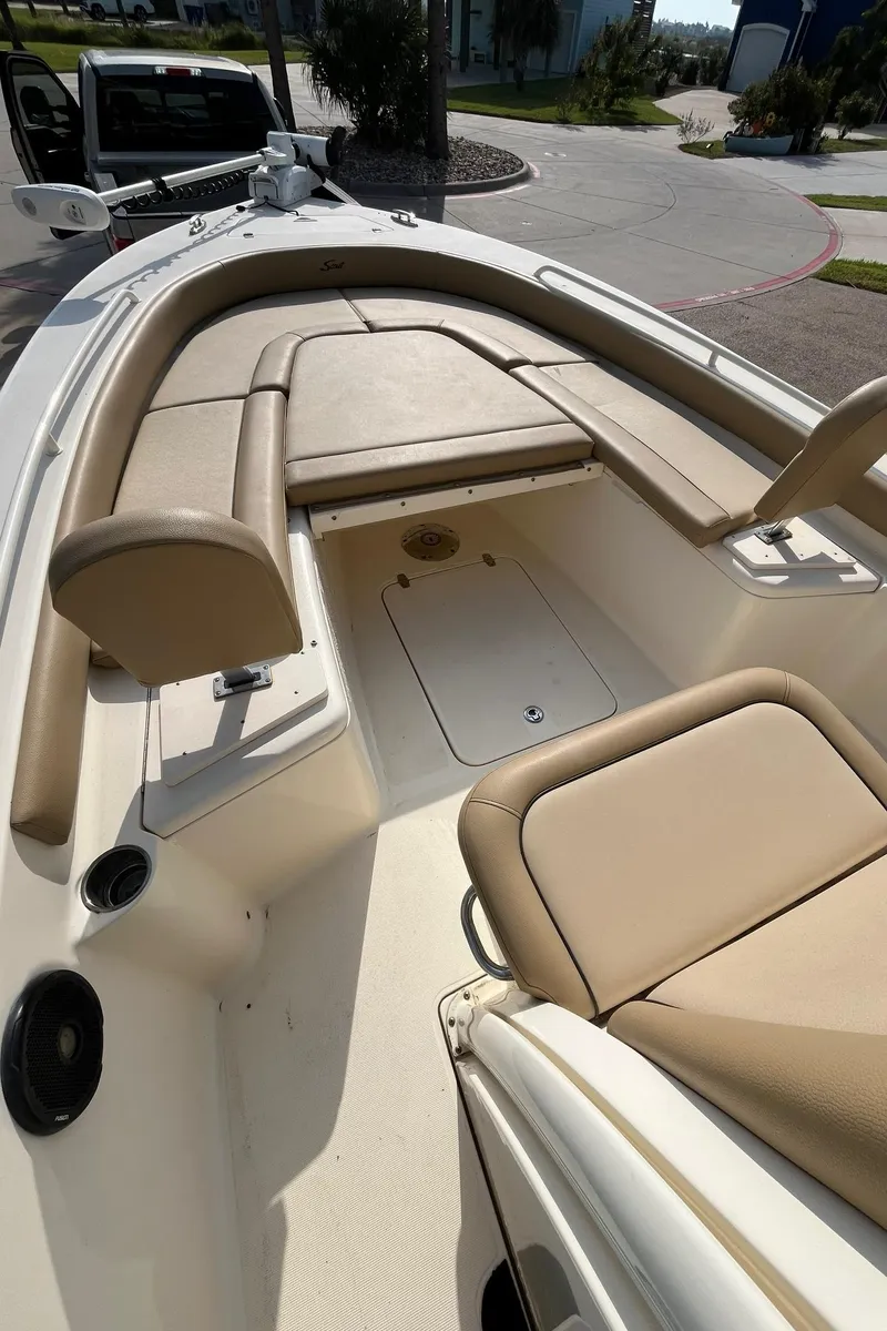 Slide: The Image of 2018 Scout 251 XSS boat interior with beige seating and spacious deck. - 15