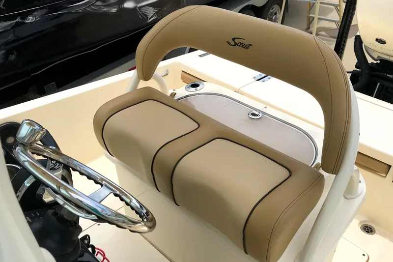 Slide: The Image of 2018 Scout 251 XSS boat interior with tan seating and steering wheel. - 16