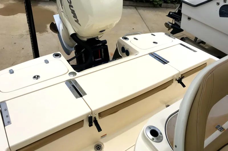 Slide: The Image of 2018 Scout 251 XSS boat deck with storage compartments and outboard motor. - 17