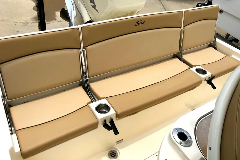 Slide: The Image of 2018 Scout 251 XSS boat seating with tan cushions and cup holders. - 18