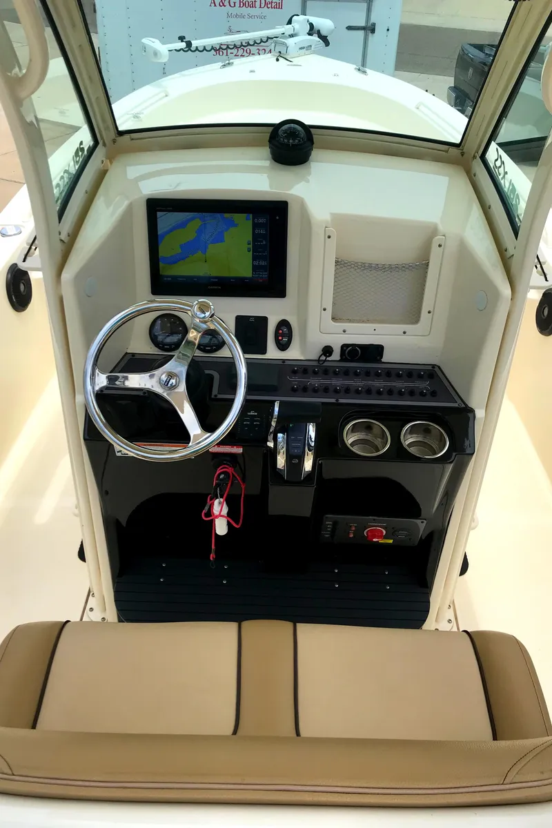 Slide: The Image of 2018 Scout 251 XSS boat dashboard with navigation screen and controls. - 21