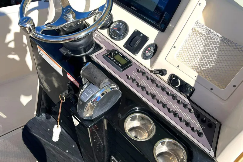 Slide: The Image of 2018 Scout 251 XSS boat dashboard with steering wheel and control panel. - 27