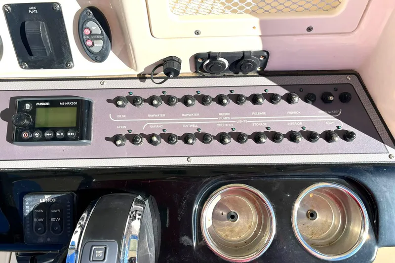 Slide: The Image of Control panel of 2018 Scout 251 XSS boat with switches and cup holders. - 28