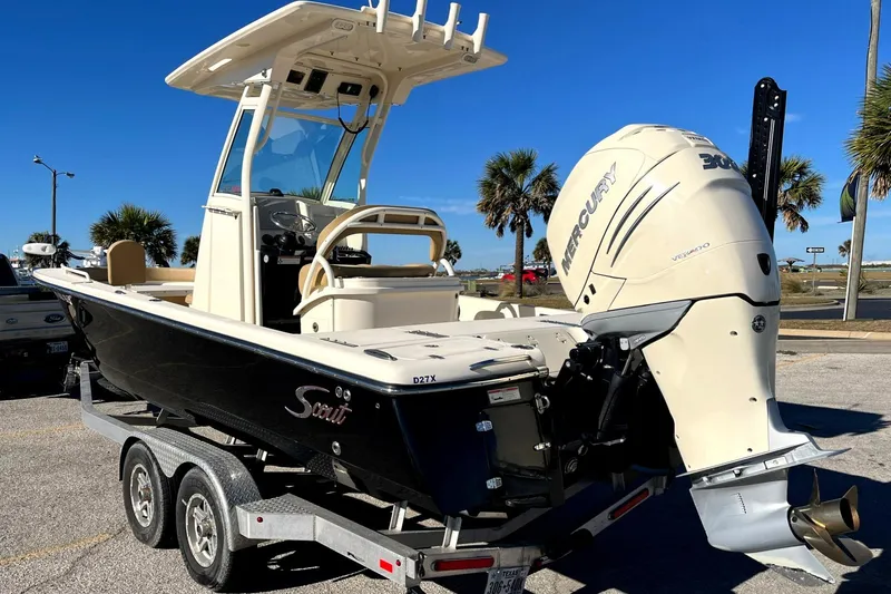Slide: The Image of 2018 Scout 251 XSS boat on trailer with Mercury engine, parked outdoors. - 5