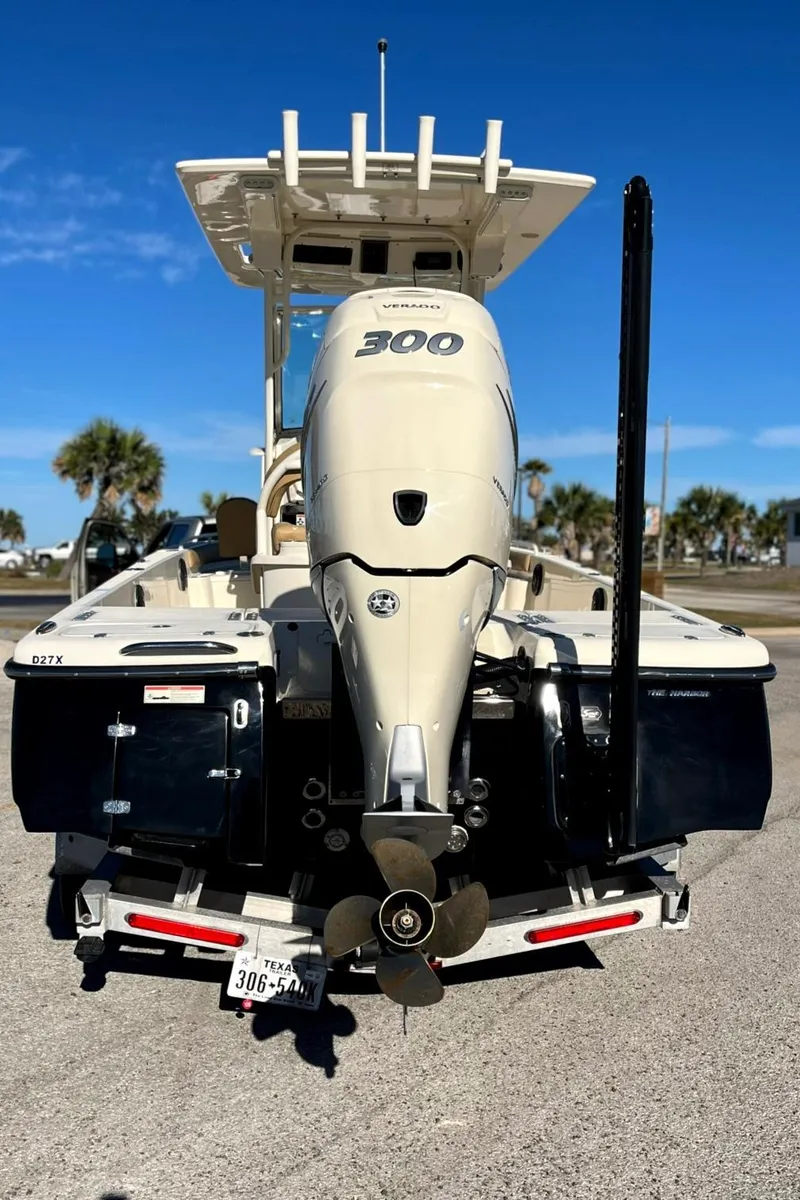 Slide: The Image of 2018 Scout 251 XSS boat with powerful 300 engine, parked on a sunny day. - 6