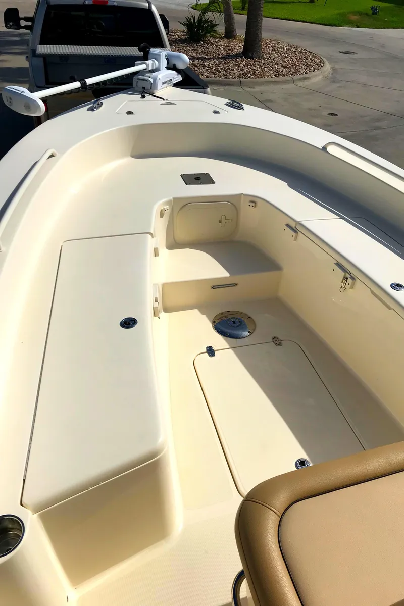 Slide: The Image of 2018 Scout 251 XSS boat interior with seating and storage compartments. - 8