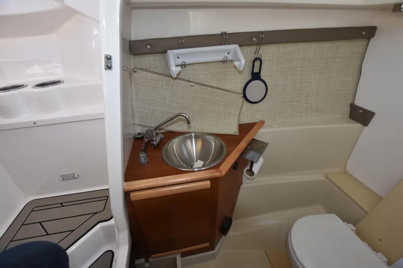 Slide: The Image of 2022 Cutwater C-24 DC boat interior with compact bathroom and sink. - 26