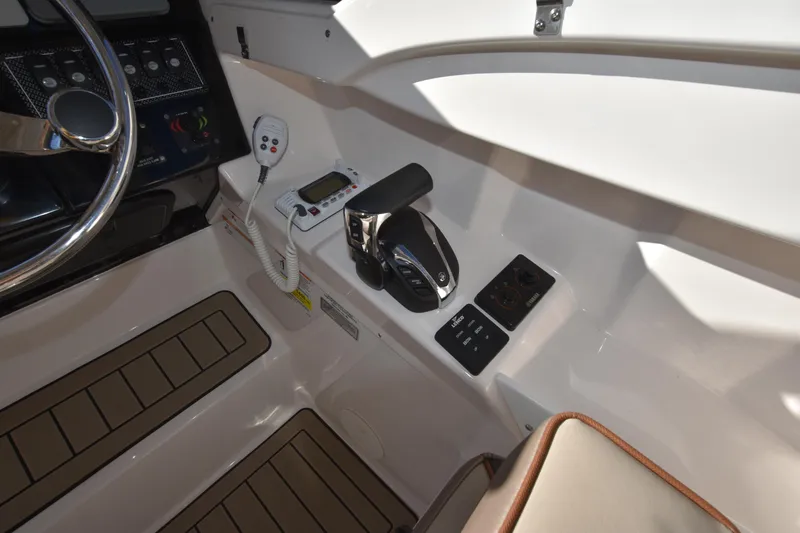 Slide: The Image of 2022 Cutwater C-24 DC boat cockpit controls and steering wheel. - 36