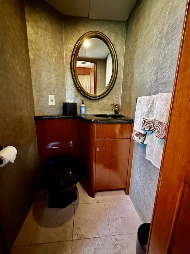 Slide: The Image of Luxurious bathroom in 2001 Dovercraft Custom RPH yacht with elegant wood cabinetry and oval mirror. - 17