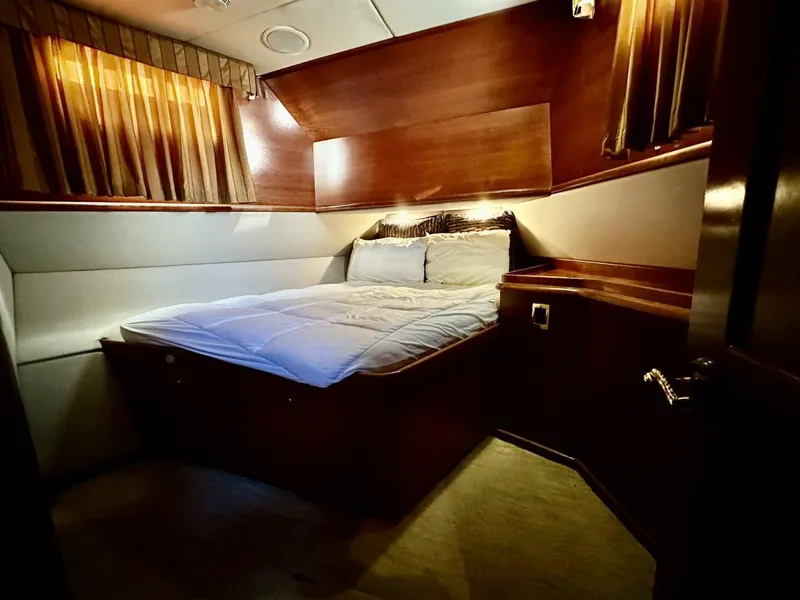 Slide: The Image of Luxurious cabin interior of 2001 Dovercraft Custom RPH yacht with cozy bed and wooden accents. - 22