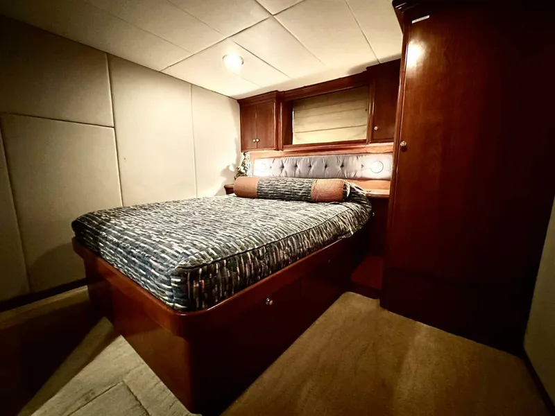 Slide: The Image of Luxurious bedroom interior of 2001 Dovercraft Custom RPH yacht with wood paneling and cozy bed. - 24