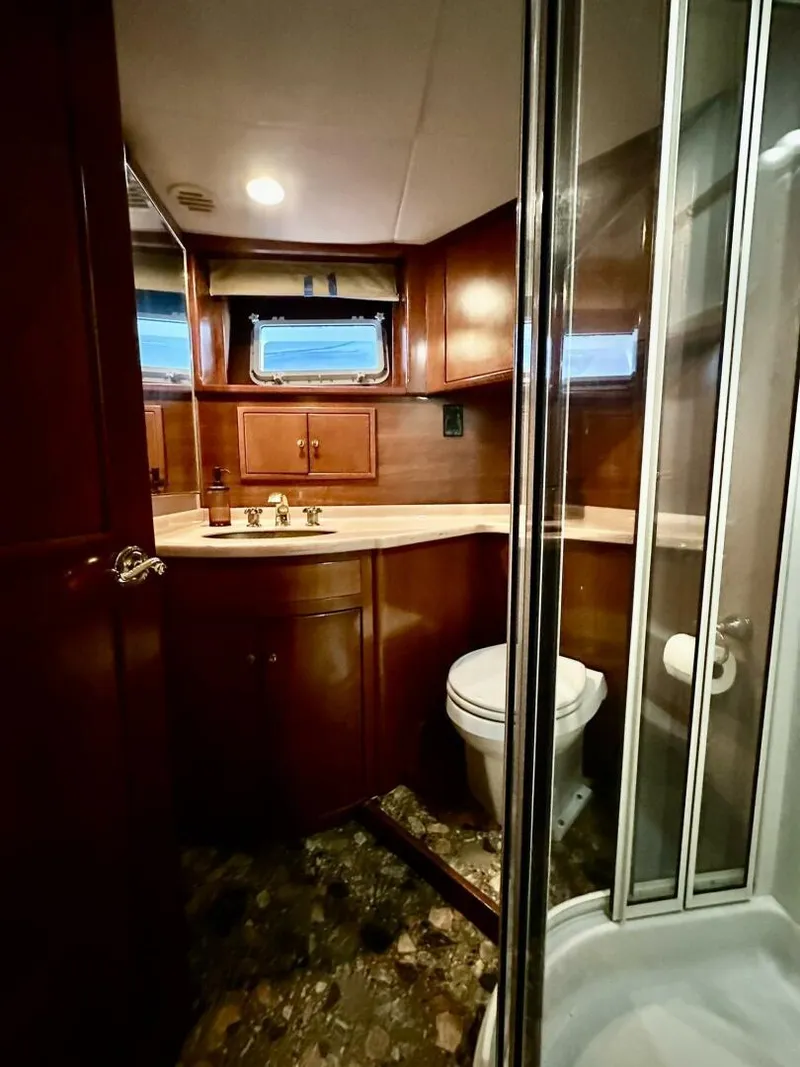 Slide: The Image of Luxurious bathroom in 2001 Dovercraft Custom RPH yacht with wood cabinetry and glass shower. - 30