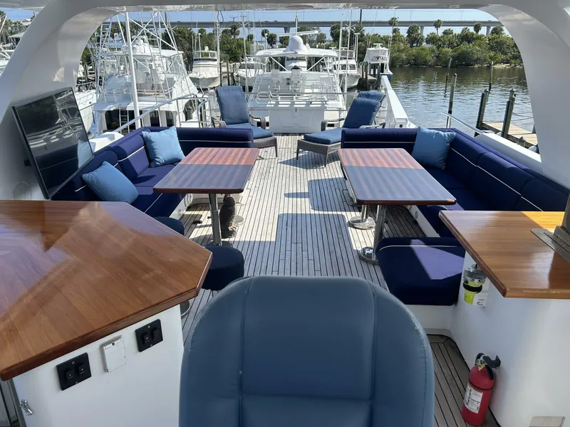 Slide: The Image of Luxurious 2001 Dovercraft Custom RPH yacht deck with seating, tables, and scenic marina view. - 39