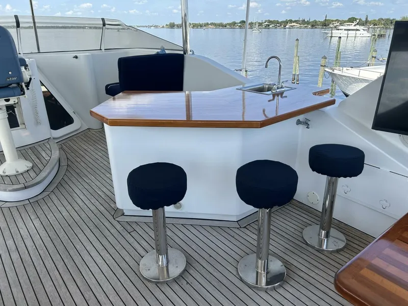 Slide: The Image of Luxury yacht bar area with stools, featuring a sleek wooden countertop and scenic water view. - 40
