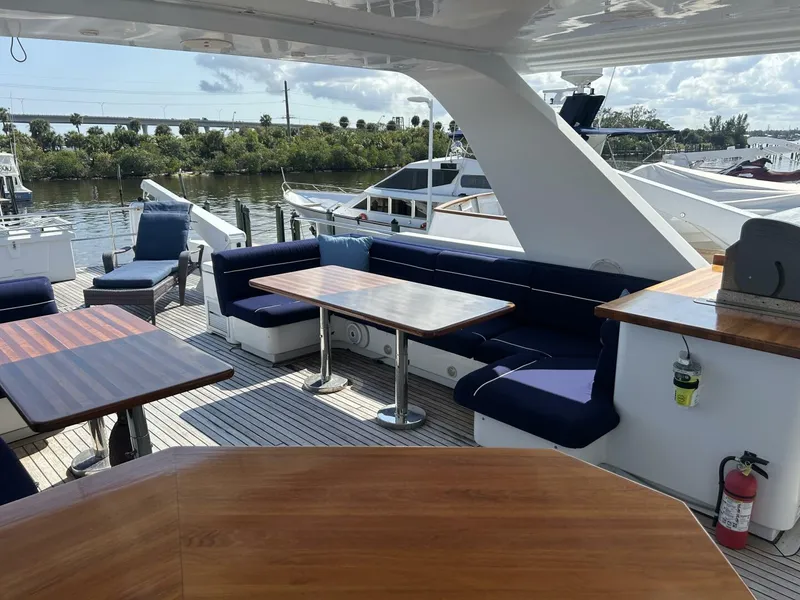 Slide: The Image of Luxurious 2001 Dovercraft Custom RPH yacht deck with seating and tables, docked by the water. - 42