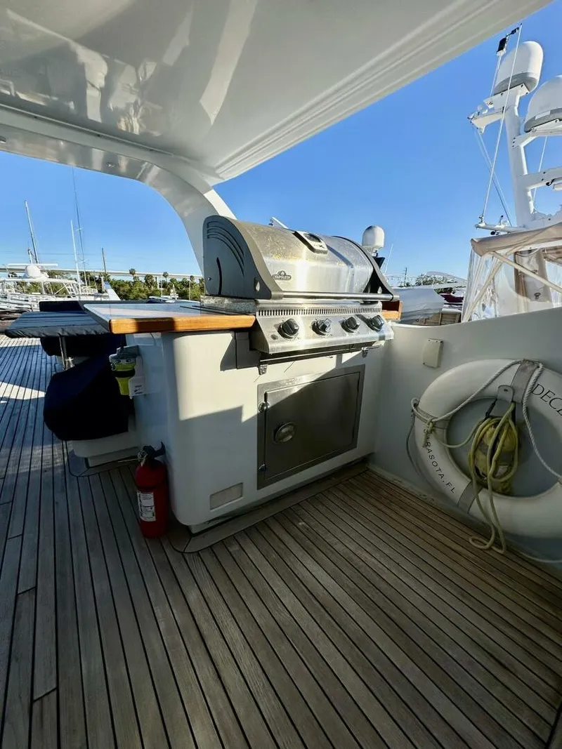 Slide: The Image of Outdoor grill on 2001 Dovercraft Custom RPH yacht deck, with lifebuoy and wooden flooring. - 43