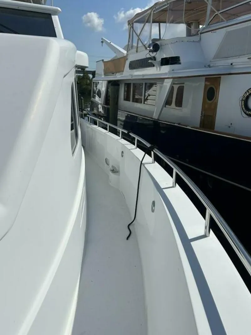 Slide: The Image of 2001 Dovercraft Custom RPH yacht docked, showcasing sleek white exterior and railing. - 45