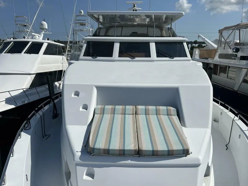 Slide: The Image of 2001 Dovercraft Custom RPH yacht with striped sunbeds on deck, docked in marina. - 46
