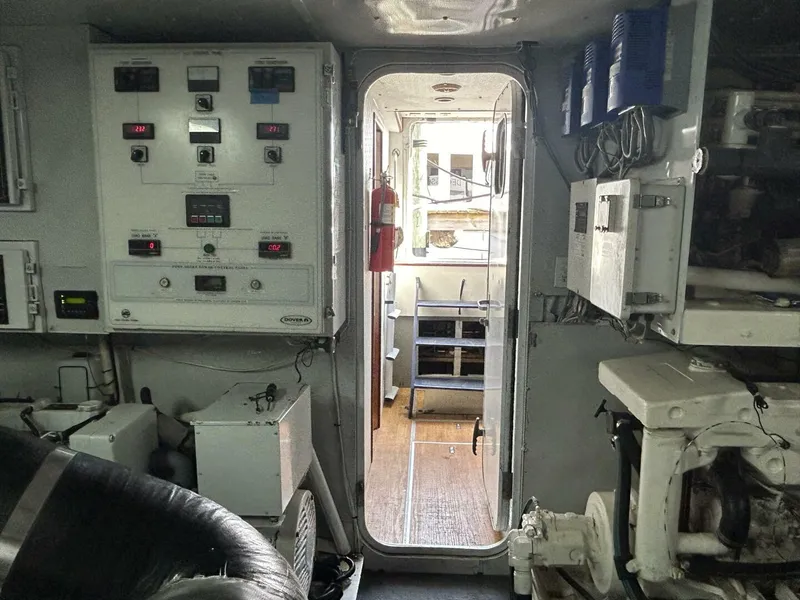 Slide: The Image of Engine room of 2001 Dovercraft Custom RPH yacht, featuring control panels and machinery. - 47
