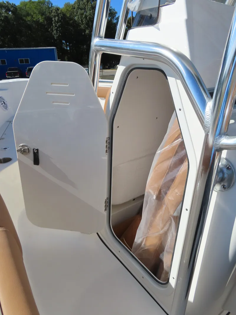 Slide: The Image of 2025 Key West 203 FS boat with open storage compartment and sleek design. - 12