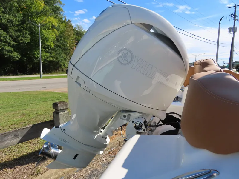 Slide: The Image of 2025 Key West 203 FS boat with Yamaha outboard motor, parked outdoors. - 14