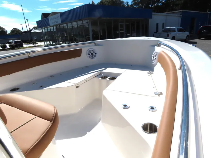 Slide: The Image of 2025 Key West 203 FS boat interior with tan seating and cup holders. - 8